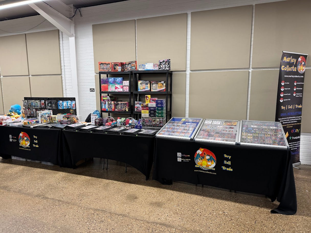 Marley Collects table setup with various items on a checkered floor and paneled wall background.
